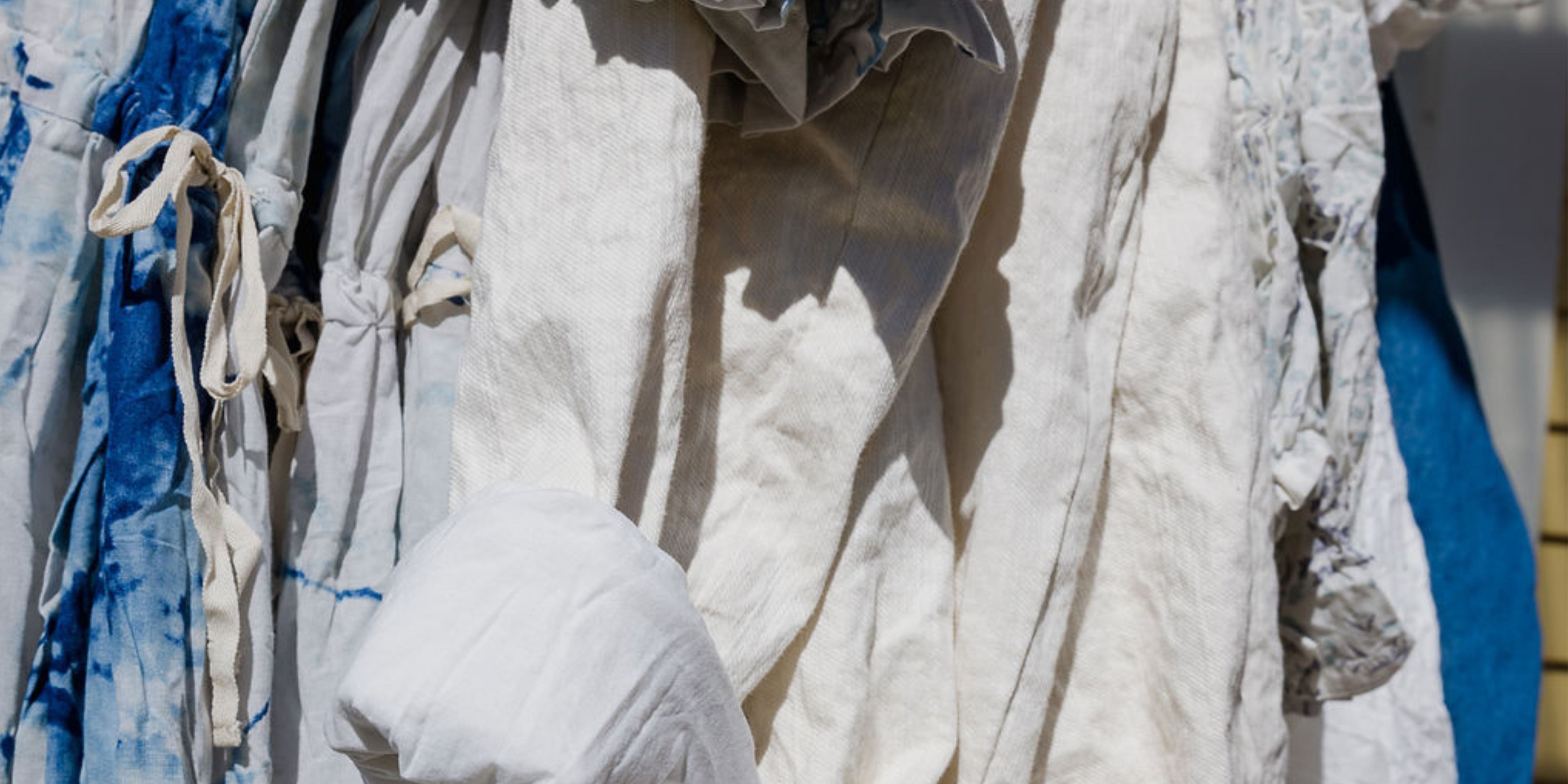 Close-up of white fabric with blue accents hanging outdoors